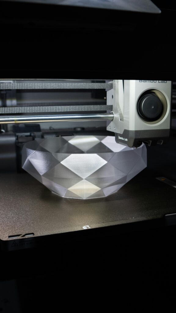 A 3D printer creating a geometric crystal-like bowl in a modern setup.